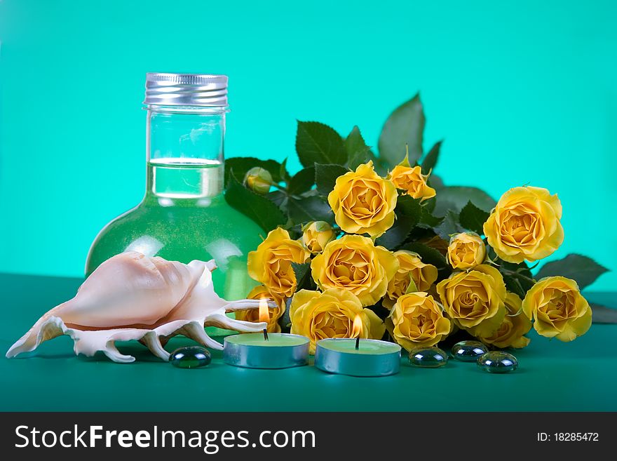 Spa still life with yellow roses on a green background