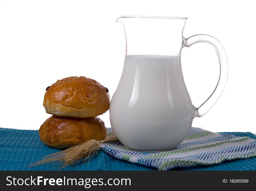 Fresh bread with glass of milk on a white background