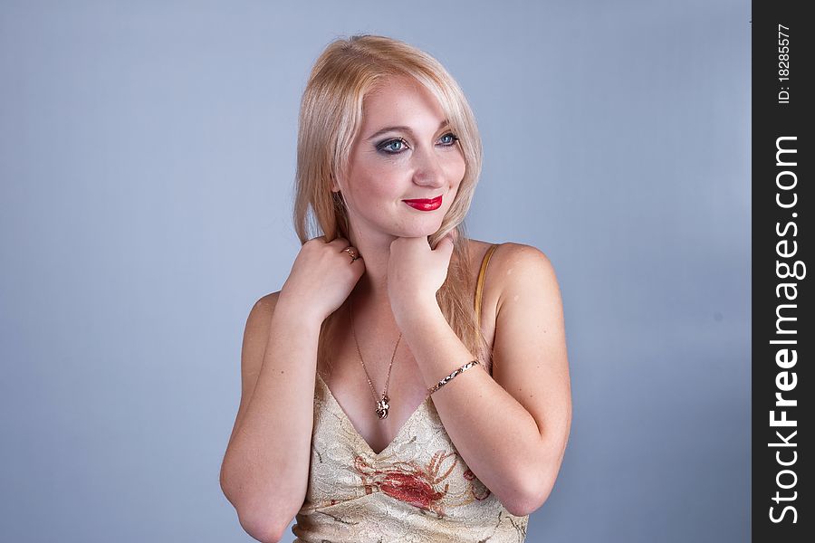 Portrait of a beautiful young lady in beige dress