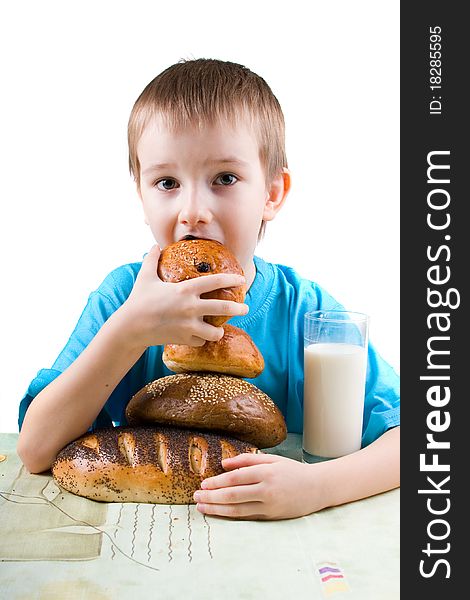 Happy boy eating bread on a white background