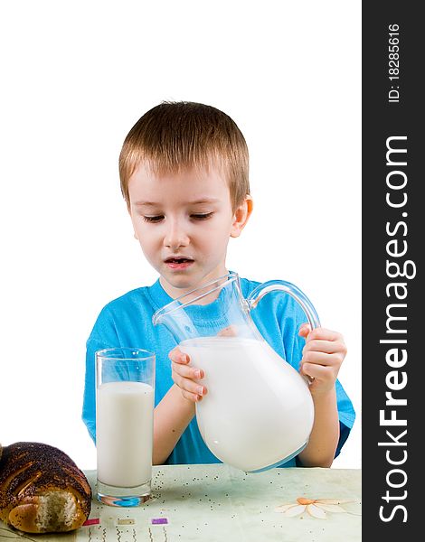 Boy with  a pitcher and a glass of milk on a white background