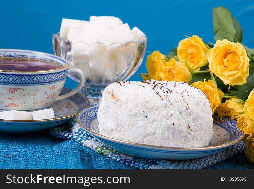 Romantic tea. Tea, cake and roses on a blue background. Valentine's Day