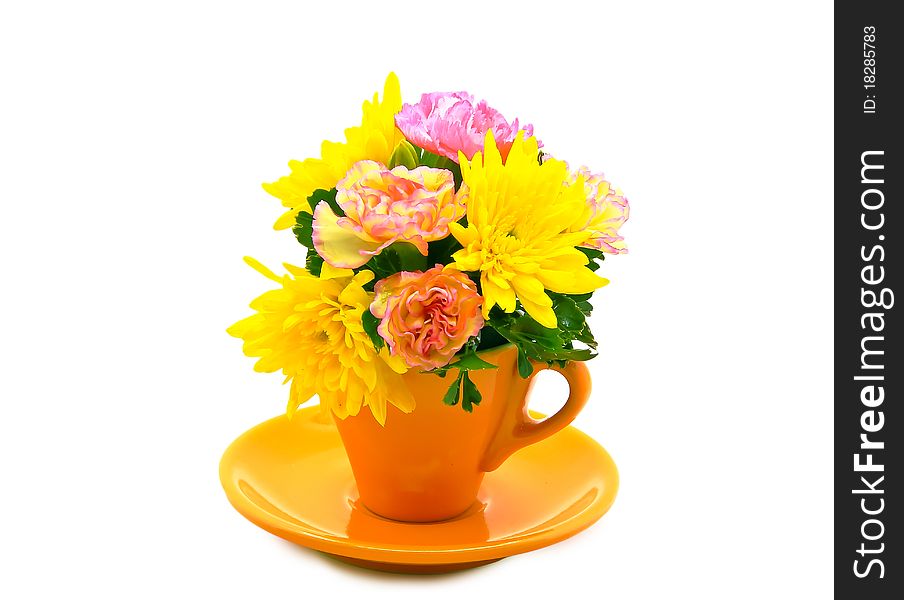 Colorful flowers in the yellow coffee cup.