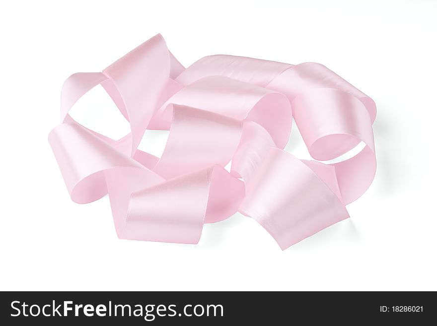 Rolled pink ribbon on a white background.