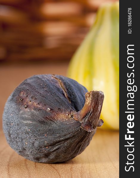 Ripe fruits of a fig on a wooden table.