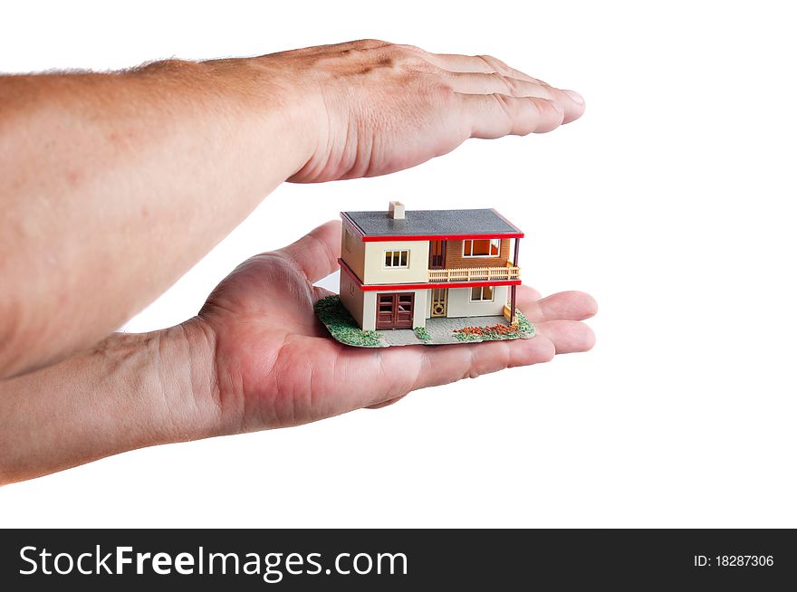 Man protecting miniature house on hand. White background