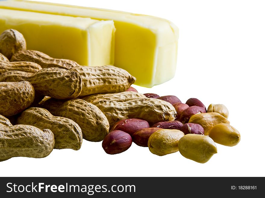 Closeup of peanuts in and out of shell with bars of butter on white background. Closeup of peanuts in and out of shell with bars of butter on white background