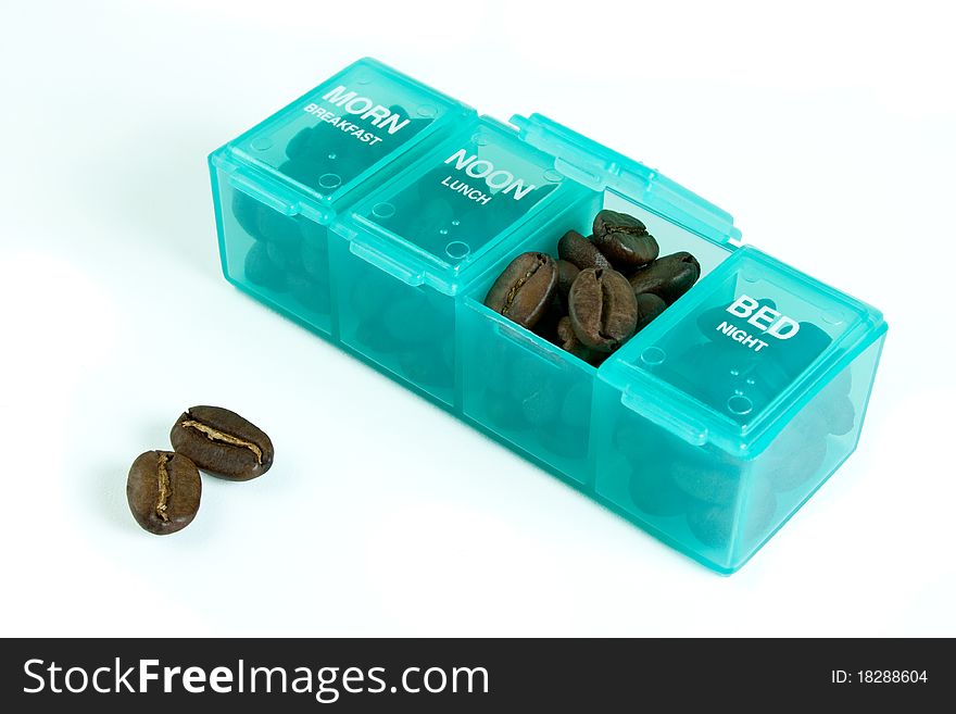 Coffee beans in a medicine daily box