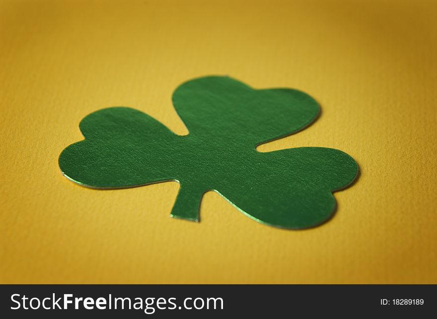 Close up of a shamrock on yellow background