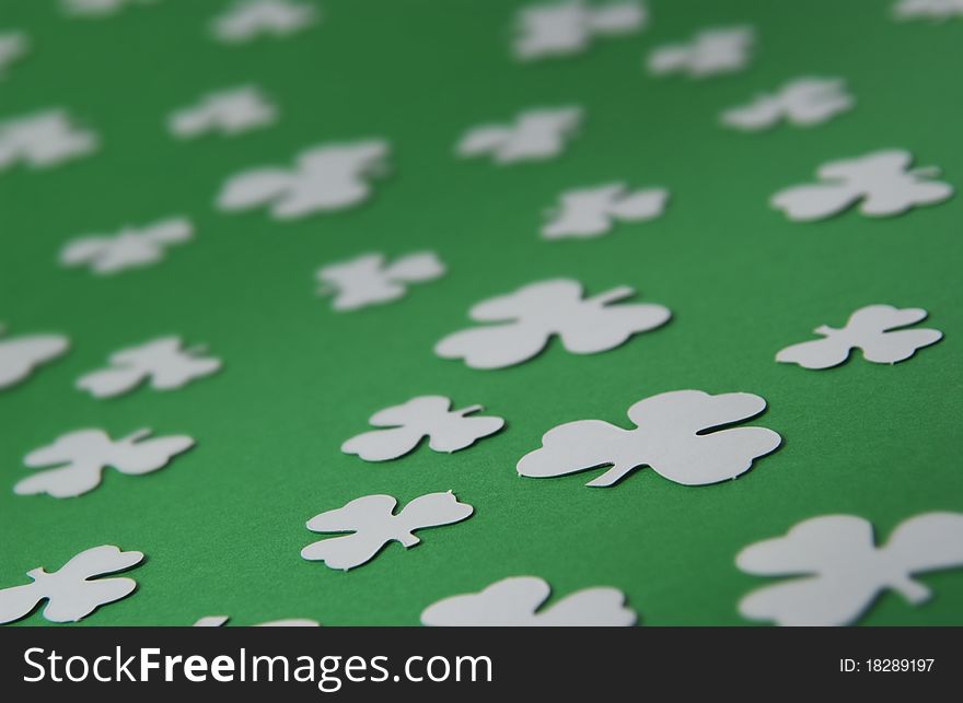 Multiple shamrock pattern on green background