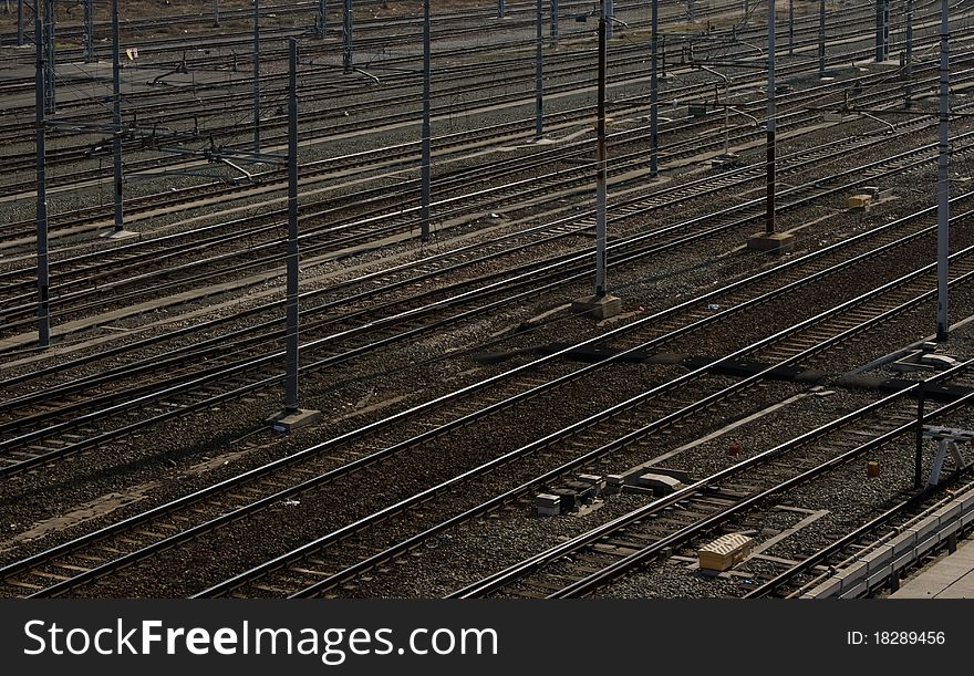 Multiple parallel railroad tracks near to Turin station.