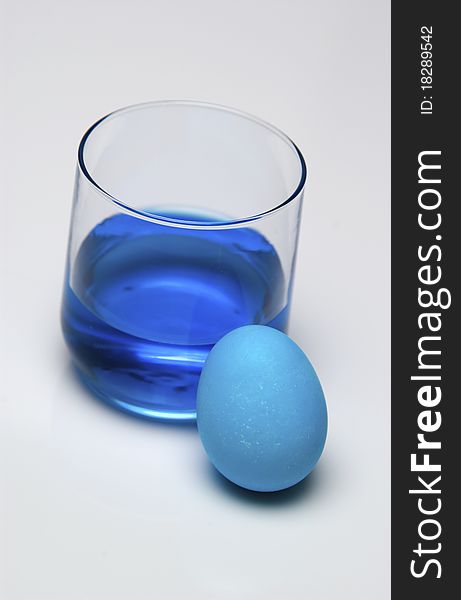 Blue dye and blue Easter egg. Blue dye and blue Easter egg