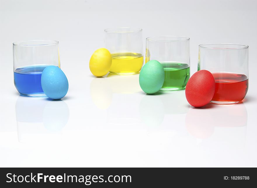 Blue, yellow, green and red dye with Easter eggs. Blue, yellow, green and red dye with Easter eggs