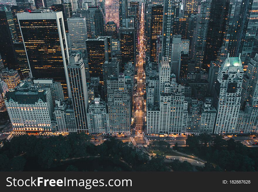 Dramatic View of Dark Epic Manhattan, New York City Avenue right after Sunset with City Lights HQ