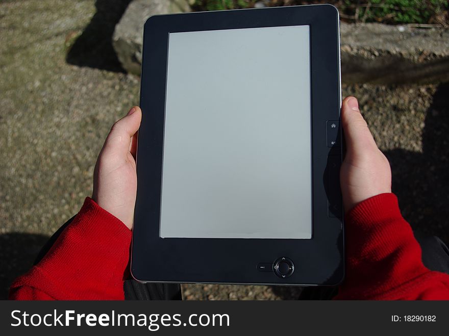 People with two hands holding the e-book