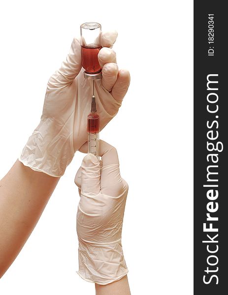 Filling of a syringe by a medicine from vial the person in gloves