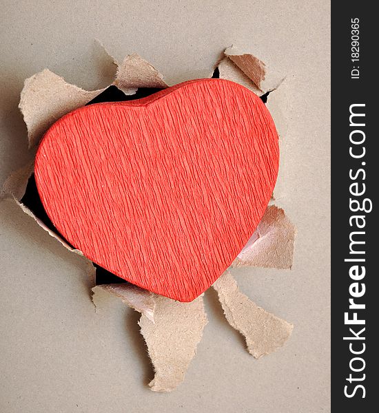 Torn gray paper and red heart. Torn gray paper and red heart