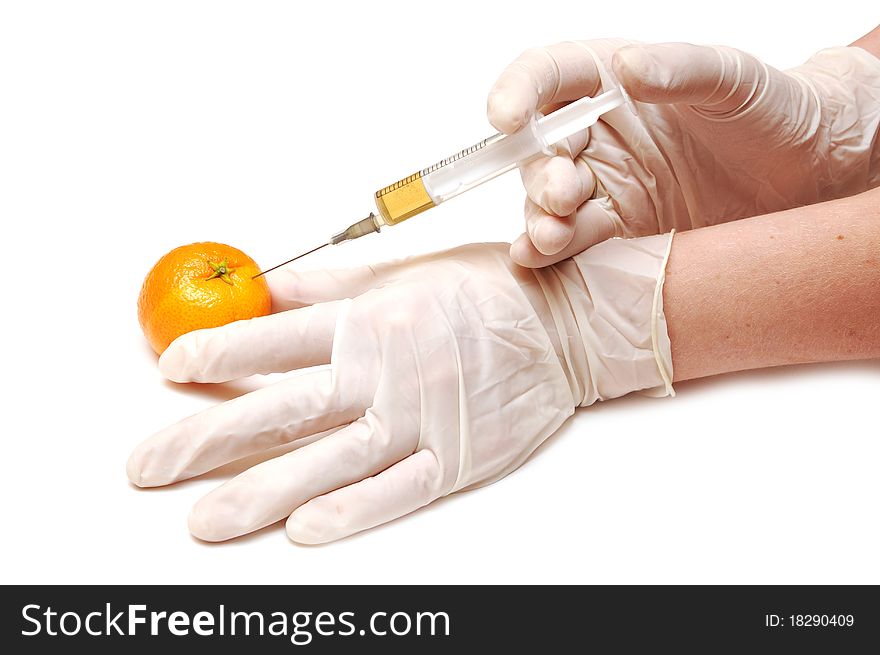 Mandarine gets an orange substance injected from hand with gloves on white
