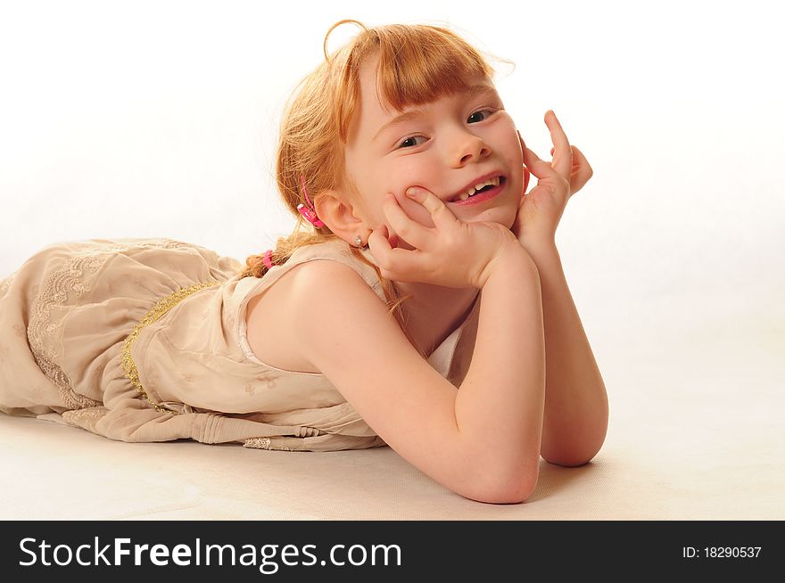 Cute Little Girl Lying On Floor