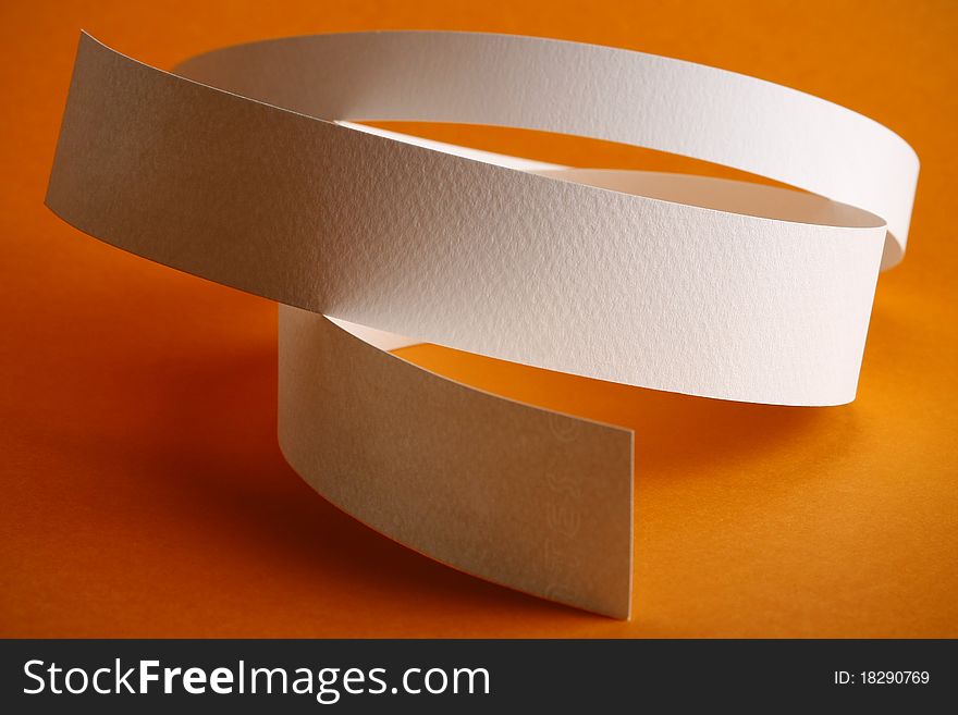 White round paper strips on orange background
