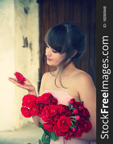 Young beautiful girl with a bouquet from roses