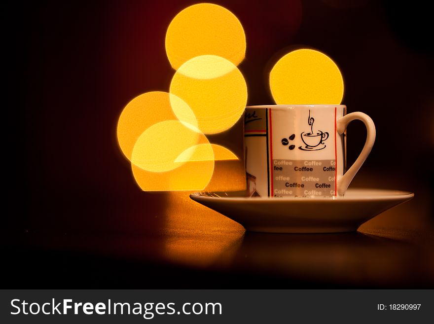 Coffee or tea cup with light reflections on the background. Coffee or tea cup with light reflections on the background.