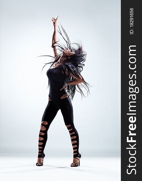 Modern style dancer posing on studio background. Modern style dancer posing on studio background