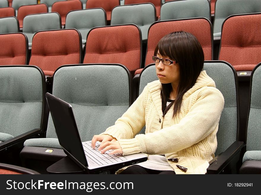 An Asian girl who is reading and studying