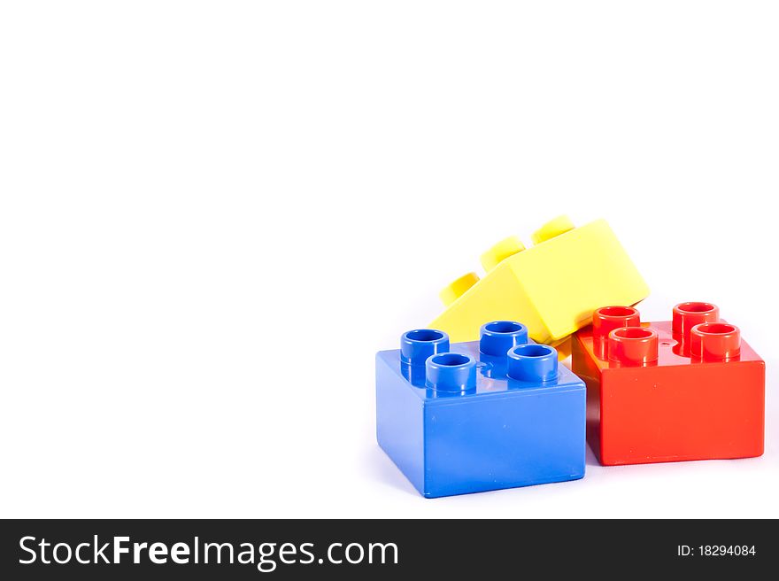 Plastic building blocks on white background. Bright colors.