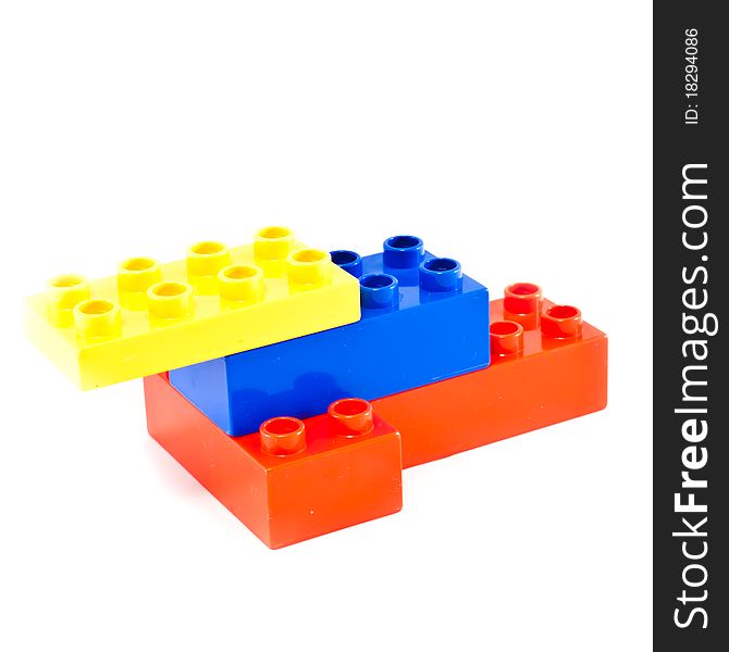 Plastic building blocks on white background. Bright colors.