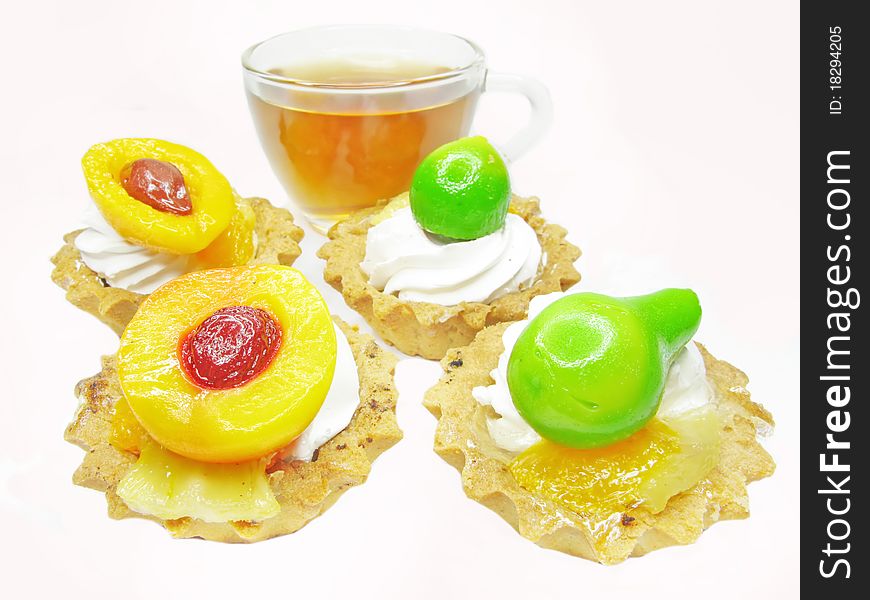 Group of fancy cakes with marmalade fruits and tea. Group of fancy cakes with marmalade fruits and tea