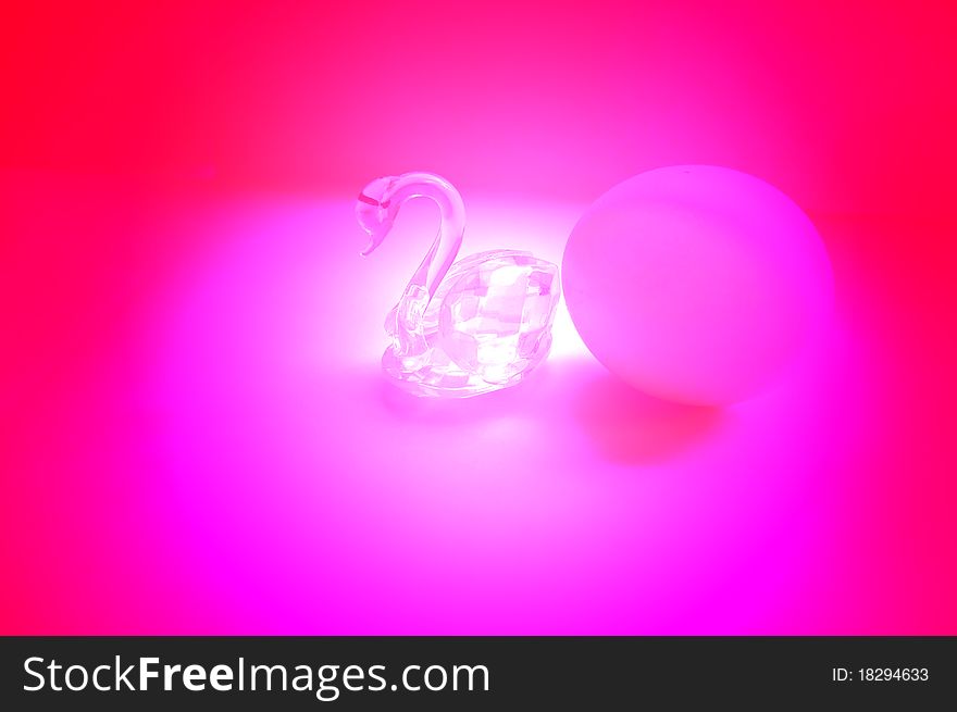 Egg and swan figure in red-pink illumination. Egg and swan figure in red-pink illumination