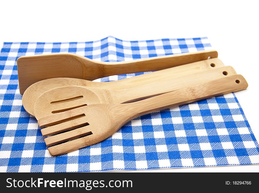 Cook spoon on blue-white checked tablecloth. Cook spoon on blue-white checked tablecloth