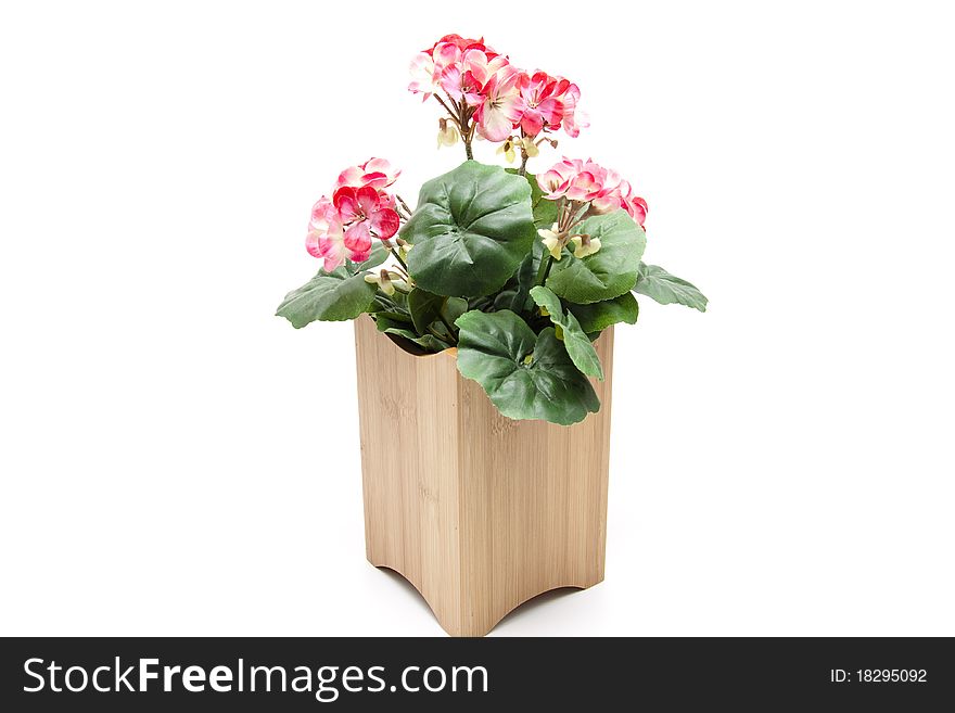 Artificial geraniums in the wood receptacle