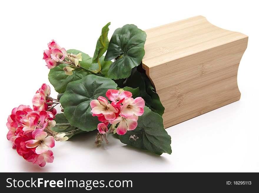 Artificial geraniums in the wood receptacle