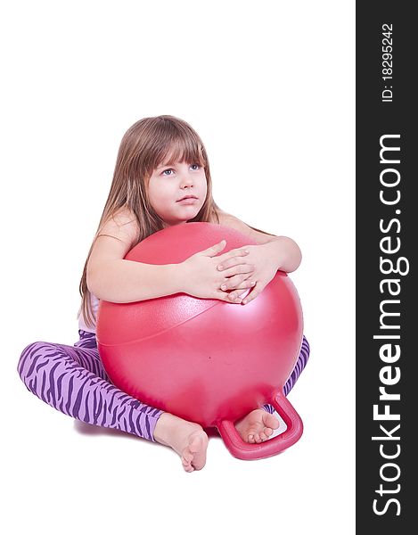 Girl exercise with a red  ball isolated on white