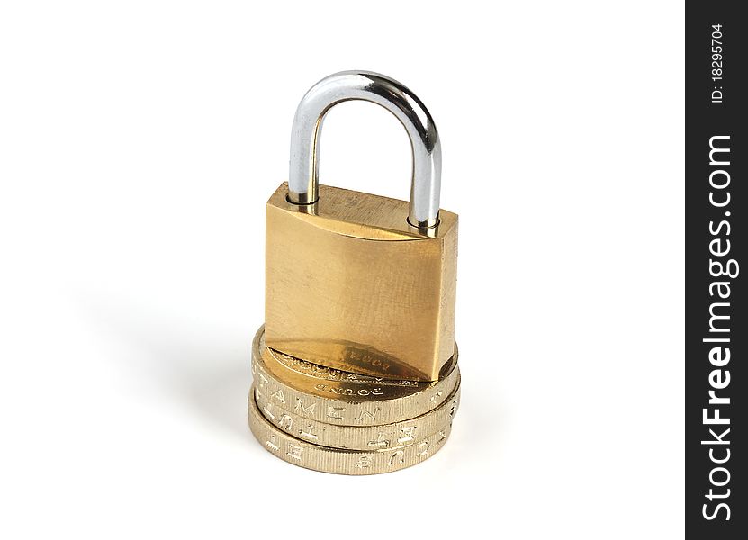 Locked closed padlock standing on a pile of coins isolated on white background. Locked closed padlock standing on a pile of coins isolated on white background