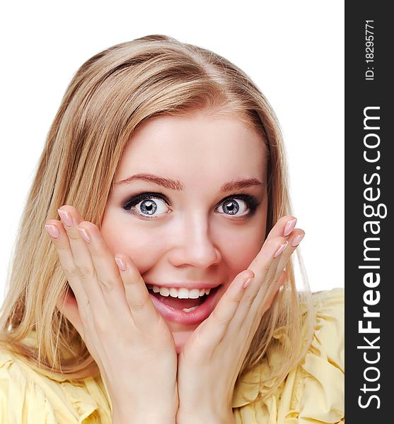 Portrait shot of a beautiful caucasian woman. Holding her face in astonishment.