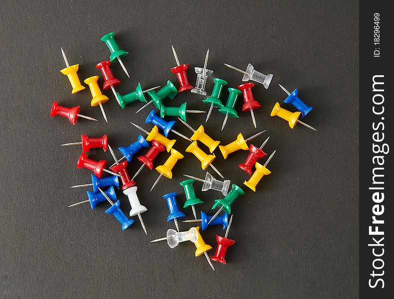 The drawing pins on a black background