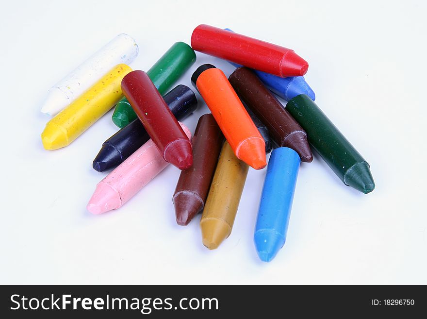 colored crayons spread over white background. colored crayons spread over white background