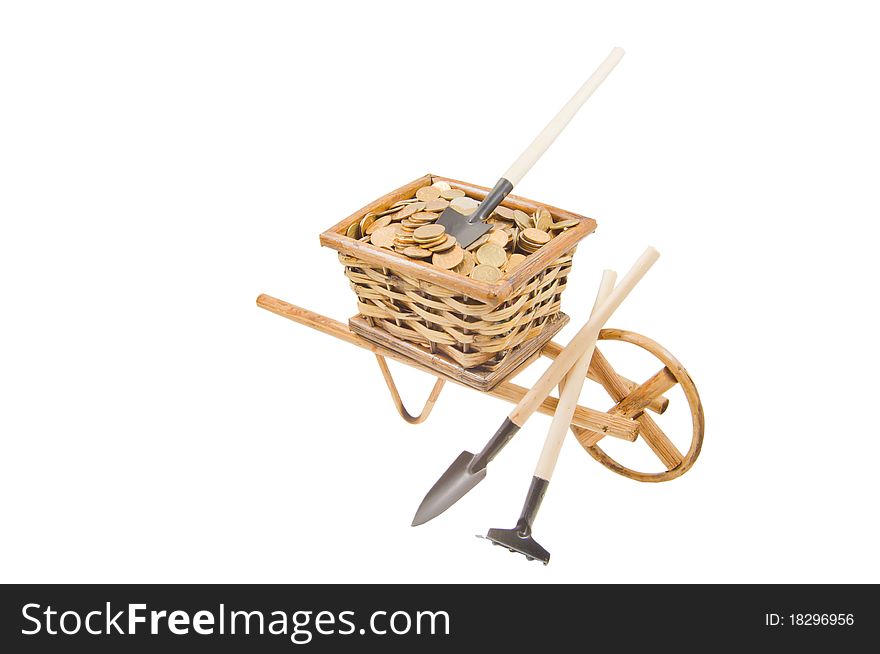The cart of money and garden tools isolated over white. The cart of money and garden tools isolated over white
