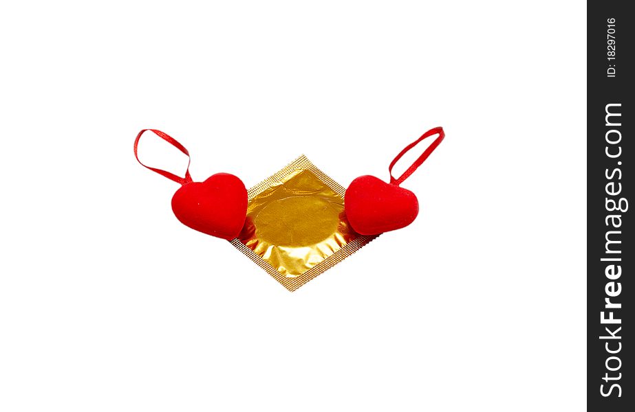 Two hearts and a condom isolated on a white background.