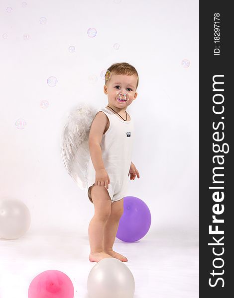 Studio portrait of little boy with wings