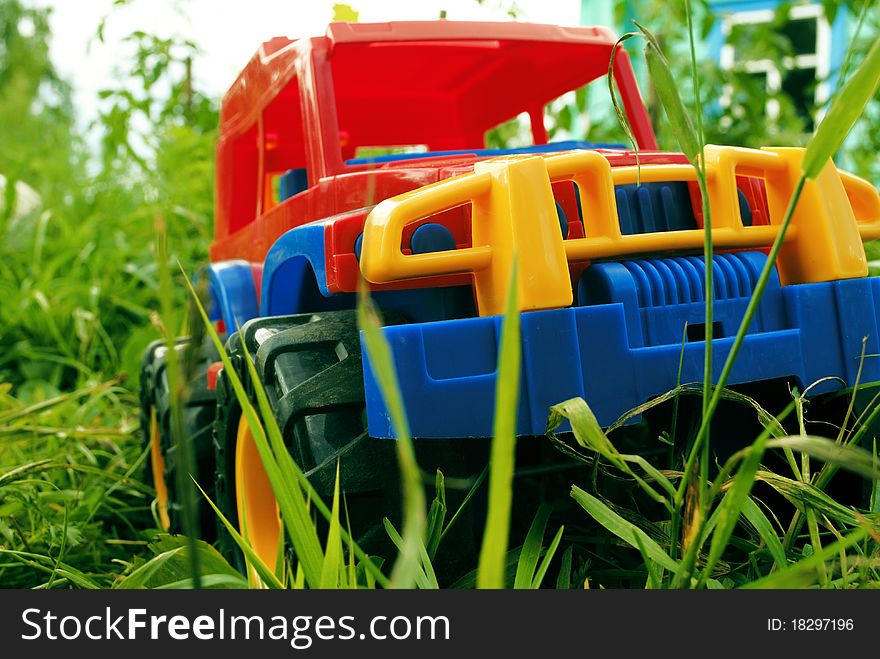 The car a toy on a green grass. The car a toy on a green grass