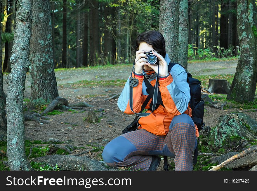 Young girl with camera in forest. Young girl with camera in forest