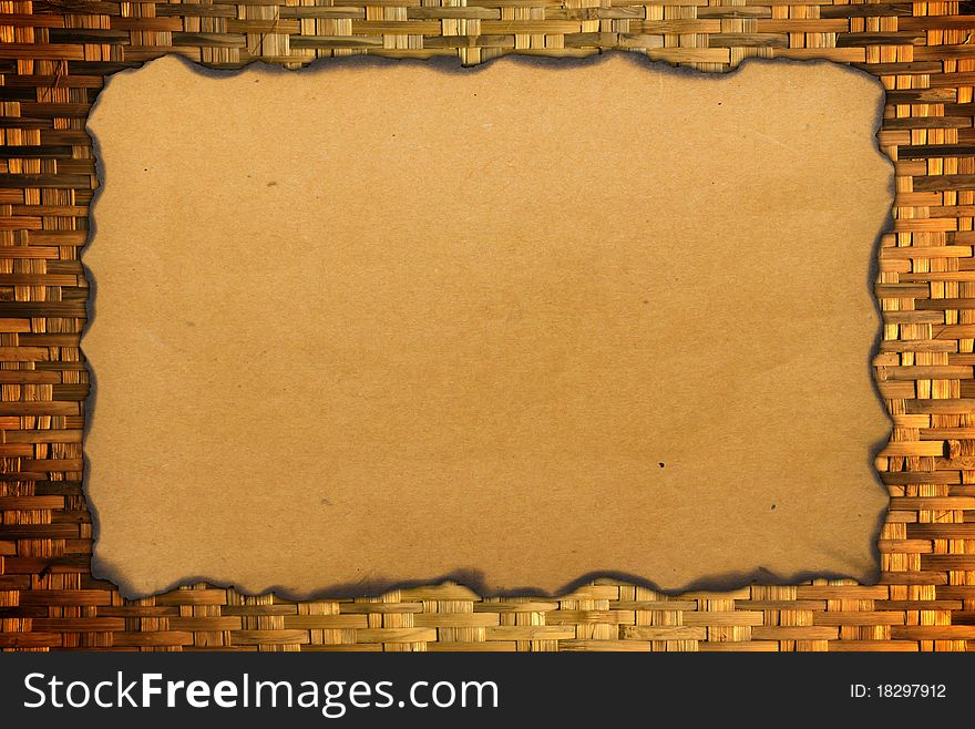 Paper with burned edges on weave bamboo background