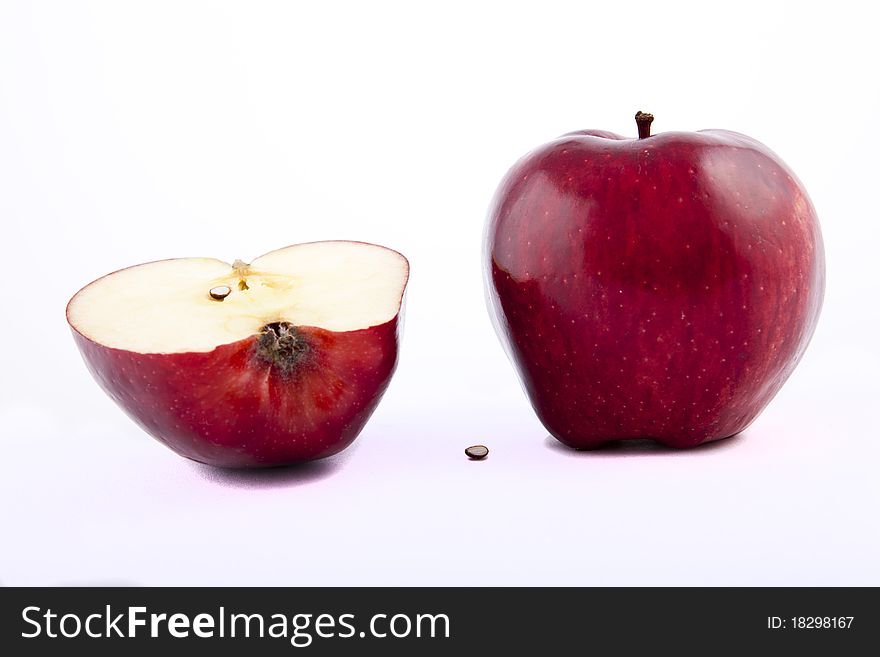 Yellow apple with brown spots on a white background