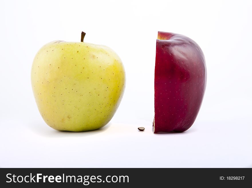 Yellow apple with brown spots on a white background