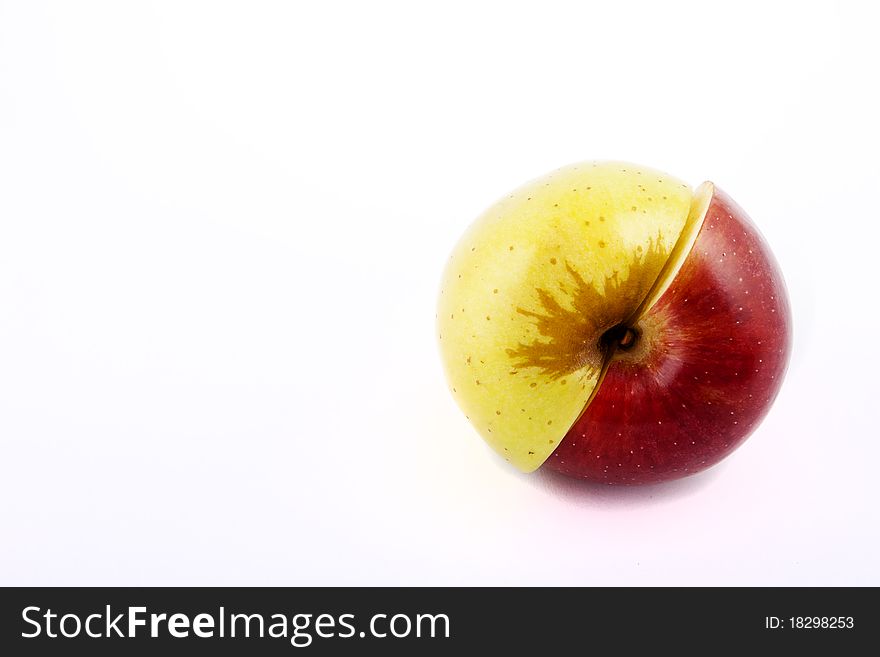 Yellow apple with brown spots on a white background