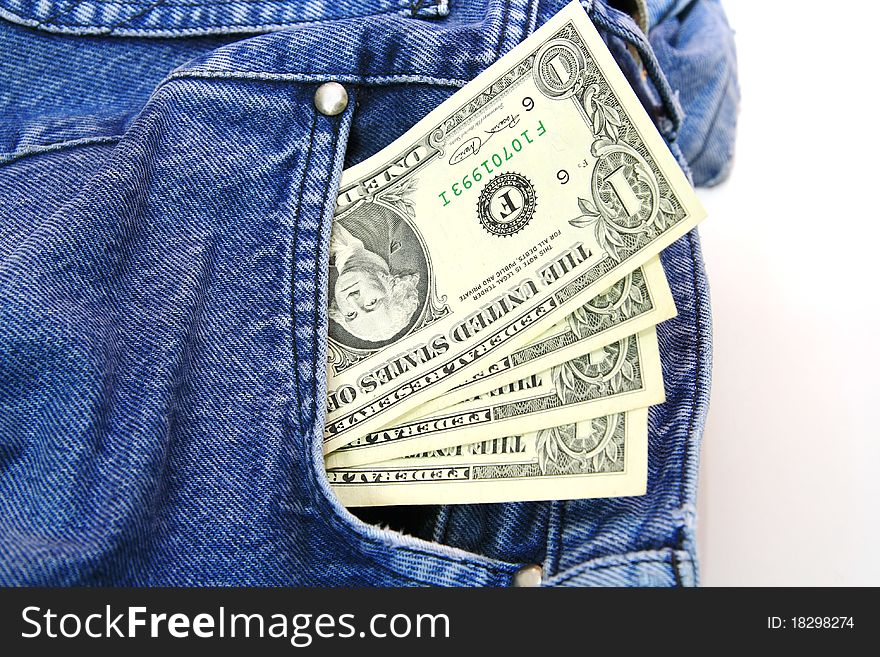 US dollar bills in blue jeans pocket.